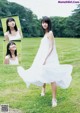 A woman in a white dress standing in a field.